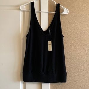 Anthropologie black tank top with band around the waist and textured fabric.
